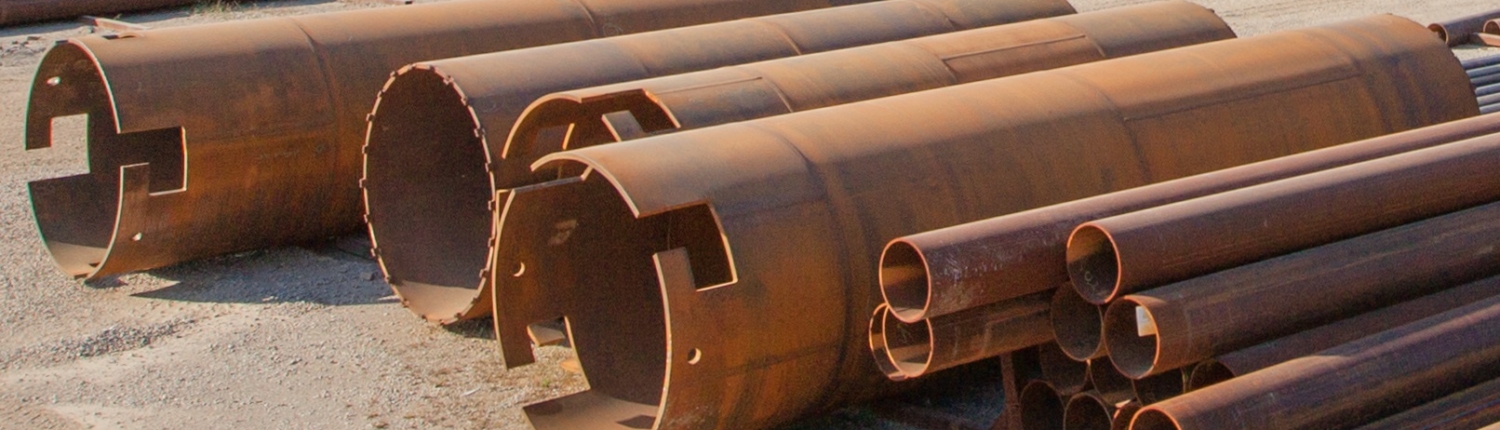 view of various sized pipes in yard