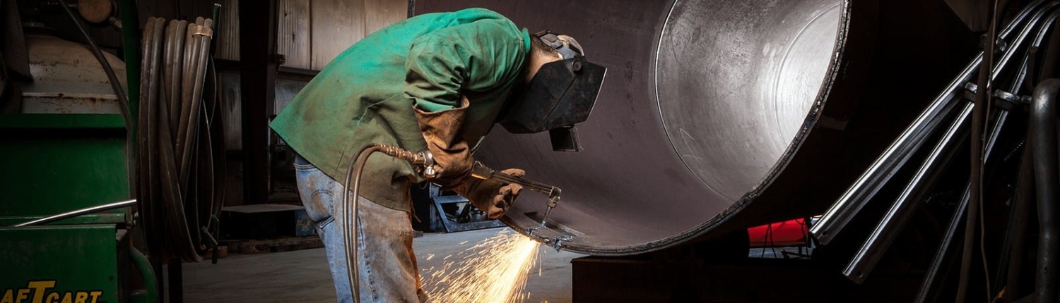 Worker using a welder on a large diameter pipe