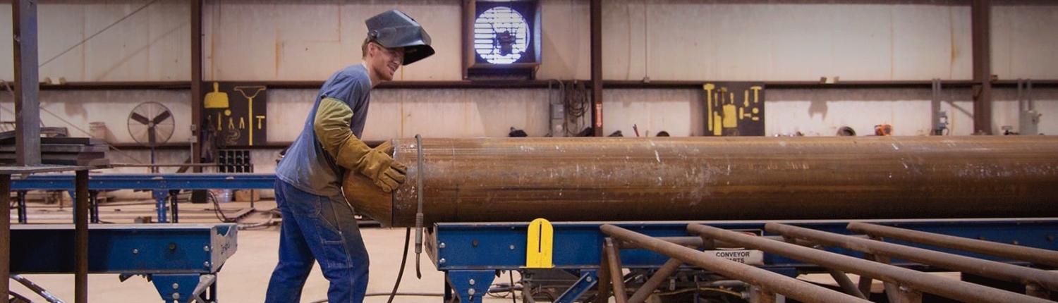 Worker operating a piling pipe machine