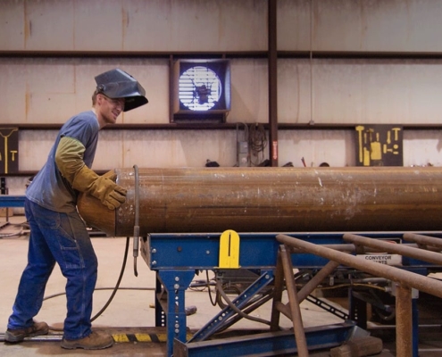 Worker operating a piling pipe machine