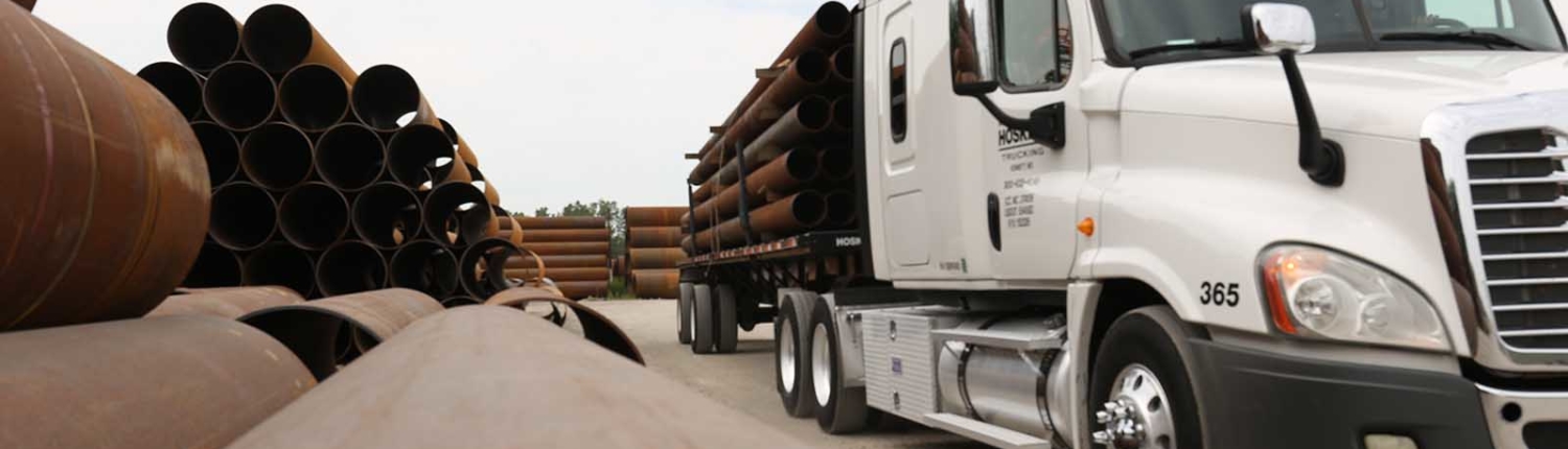 close up view of truck carrying pipes