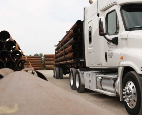 close up view of truck carrying pipes