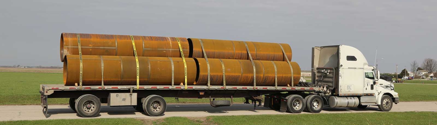 large pipes on a flat bed truck