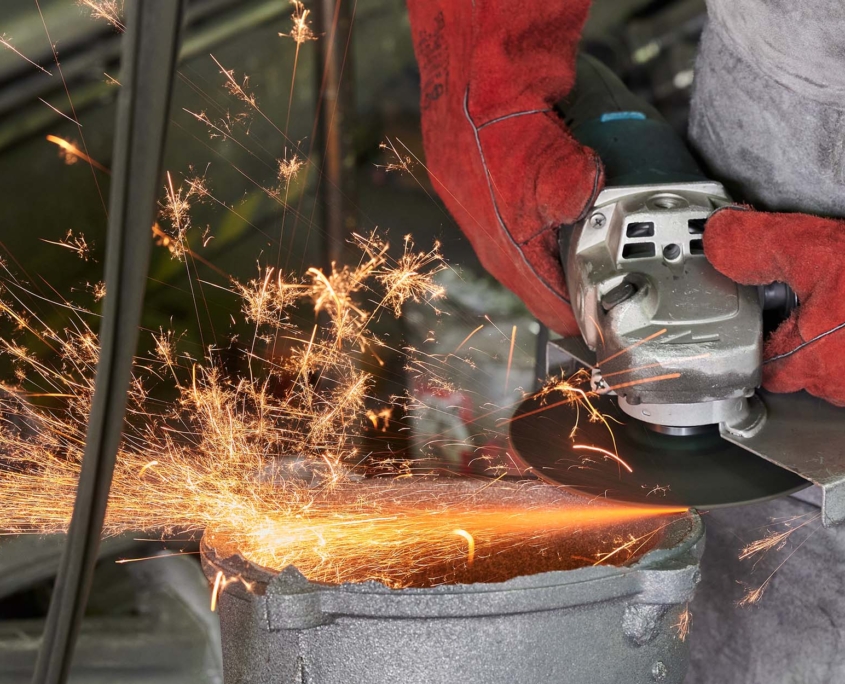 Person Using Tools to Bevel Pipe