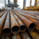 Drill Pipe. Stack of Rusty Steel Pipes in Oil Industry Warehouse